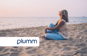 Woman relaxing on a beach featuring the Plumm logo